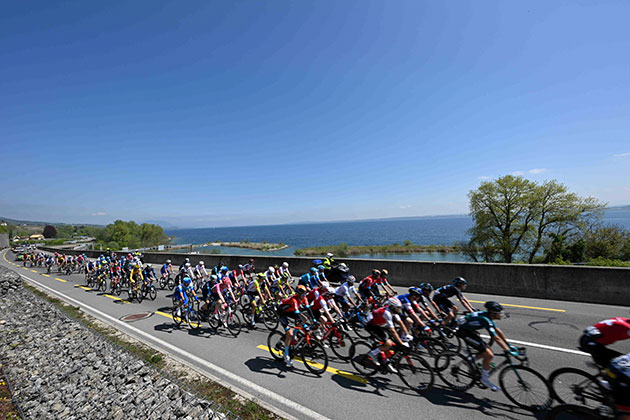 Tour de Romandie peloton rides by Lake Neuchatel